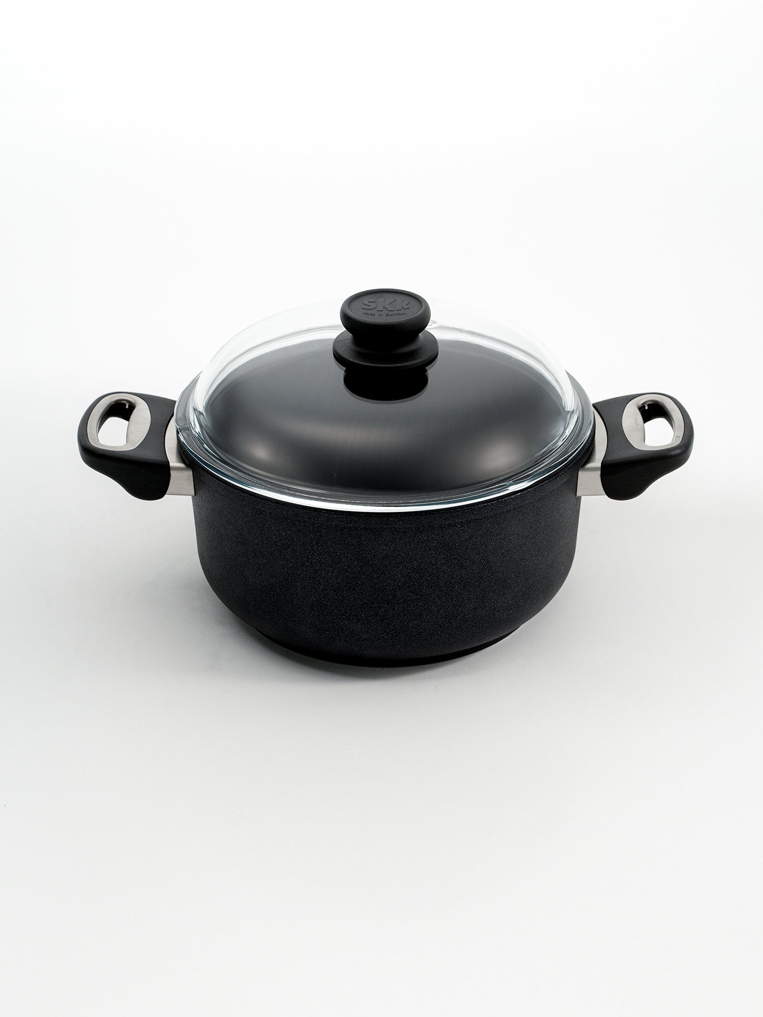 SKK Classic hand-cast tall cooking pot with glass lid, angled view — Made in Germany